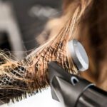 Young woman at a hair salon with hairdresser ,hair drying
