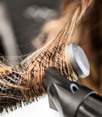 Young woman at a hair salon with hairdresser ,hair drying